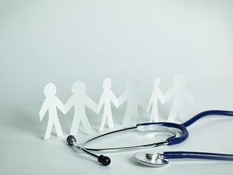 Paper cut outs of people and a stethoscope